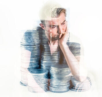 Business owner sitting behind stacks of coins, thinking about whether DigiBuur’s AI automation is worth the investment.